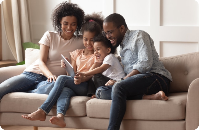 family on couch with ipad